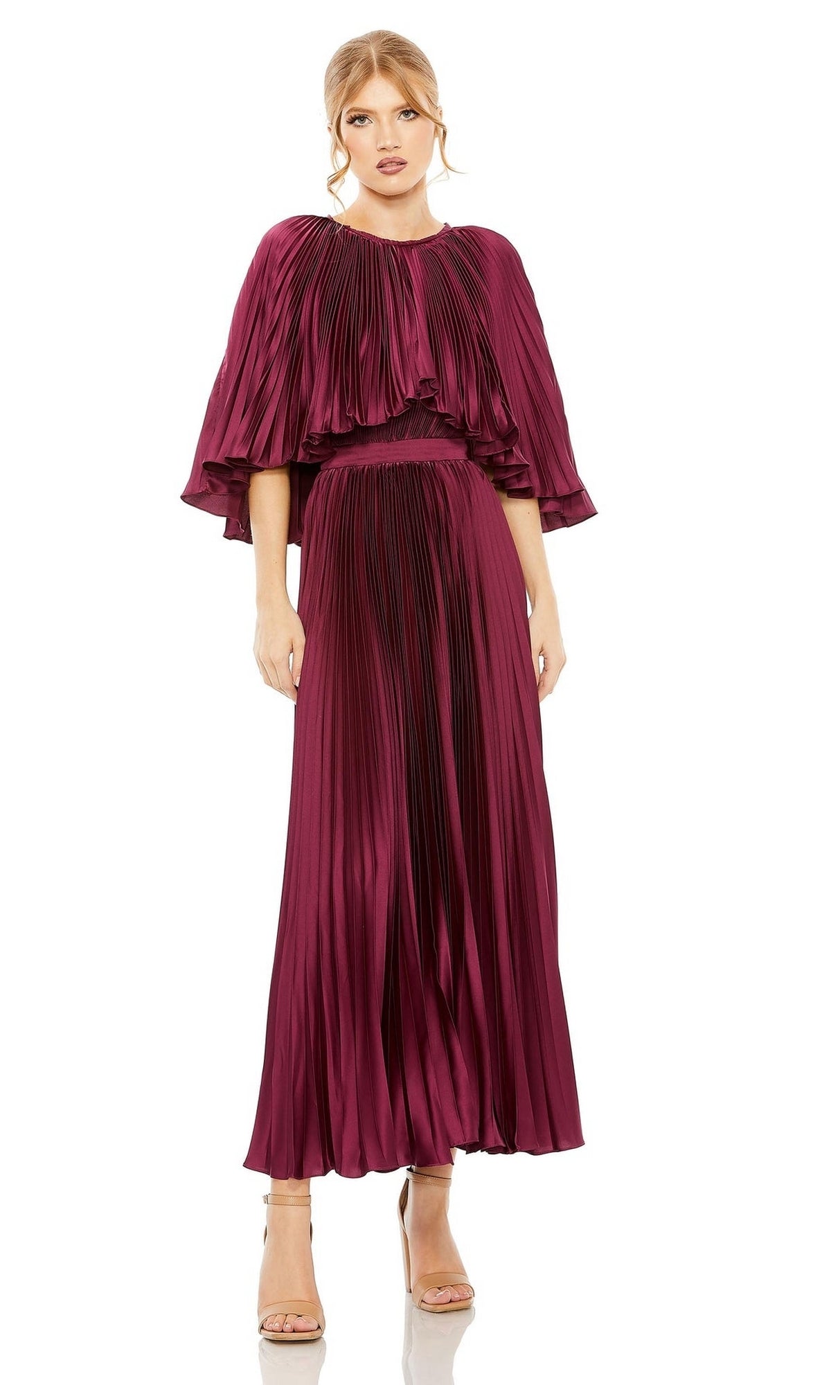 A woman wears the Mac Duggal 49638 Caped Tea-Length Party Dress in magenta with pleats and cape-style sleeves, paired with nude heels, standing against a white background.